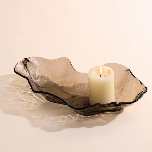 A brown glass bowl with an irregular shape