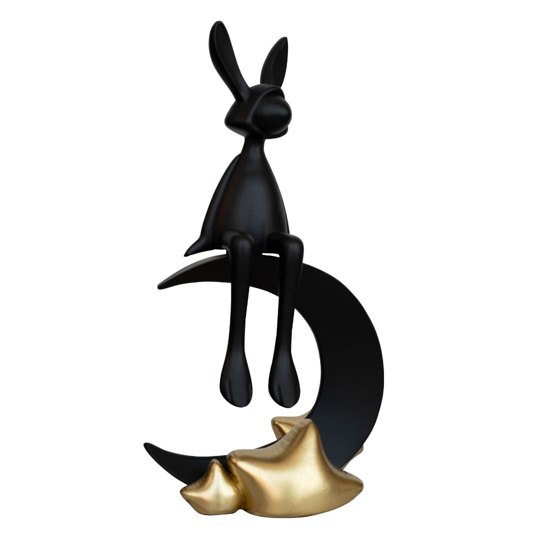 A contemporary black rabbit sculpture with a gold moon accent