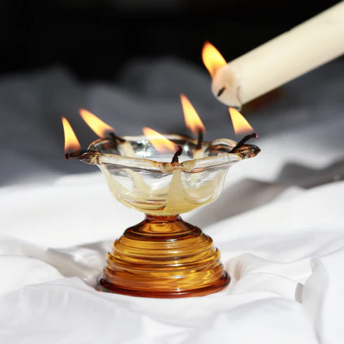 A clear glass diya 
