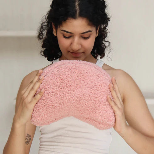 A pink crescent shaped cushion 