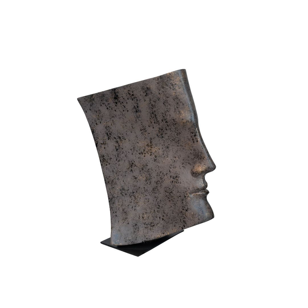 An abstract sculpture depicting a face profile emerging from the pages of an open book