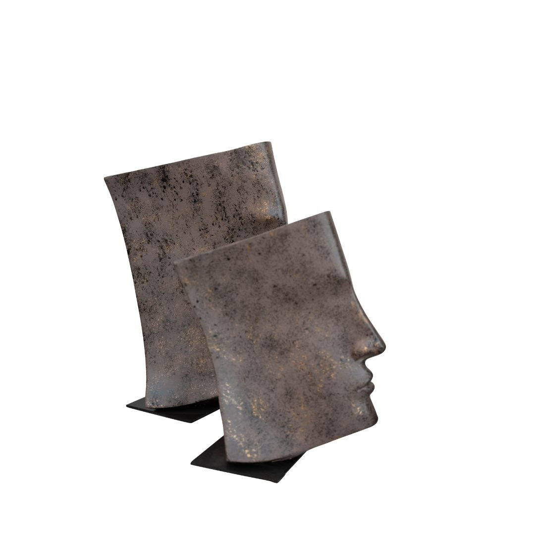 An abstract sculpture depicting a face emerging from an open book