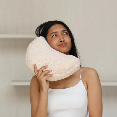 A white, organic-shaped cushion 