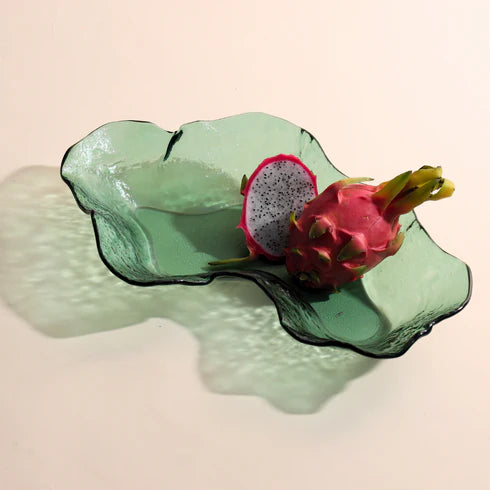 A moss green, glass bowl with an irregular shape