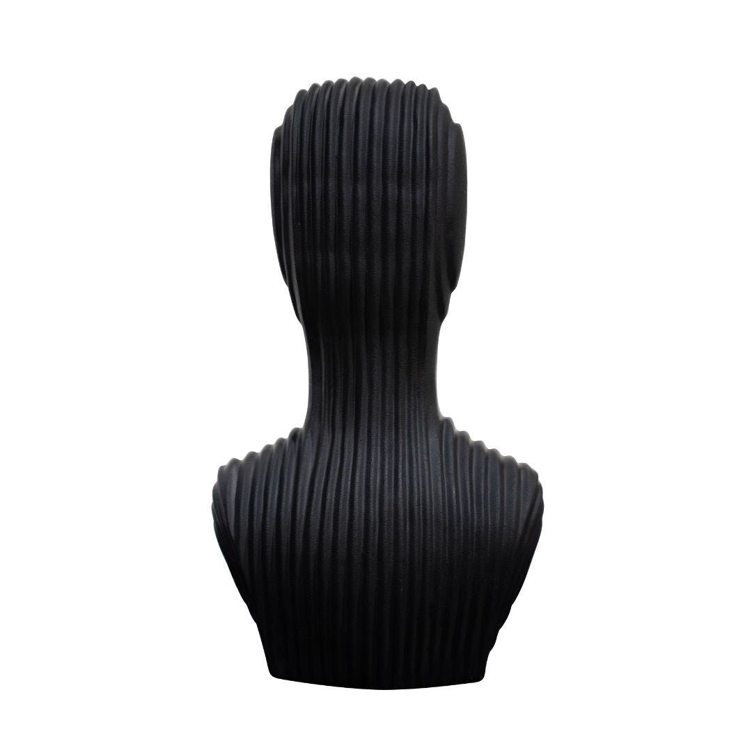 A modern black bust sculpture with a vertically ribbed texture