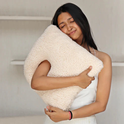 A white, organic-shaped cushion 