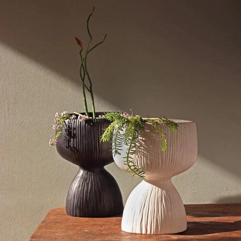 A set of white and black, marble planters.