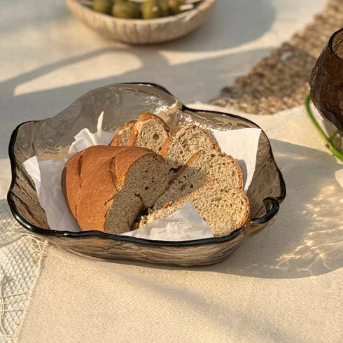 A brown glass bowl with an irregular shape