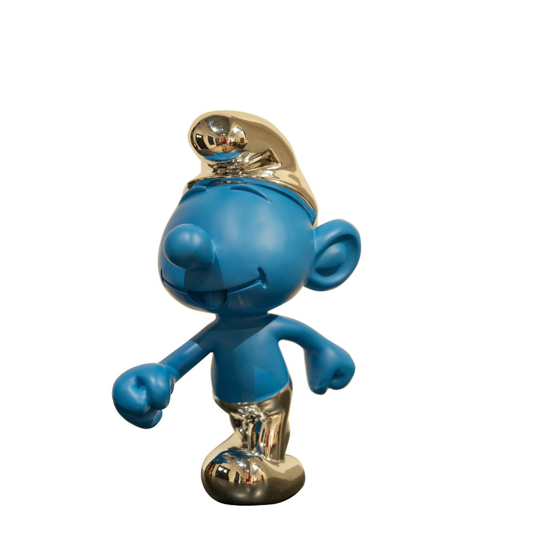 A blue Smurf sculpture with silver accents on its hat and shoes