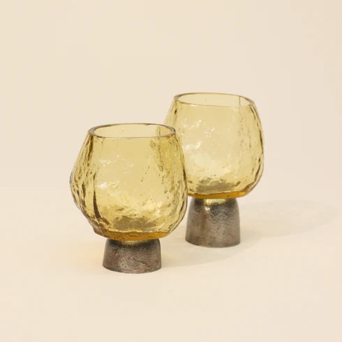 Two gold colored glass tea light candle holders 
