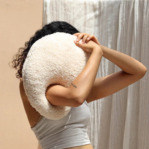 A white, organic-shaped cushion 