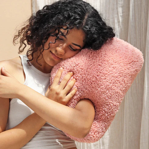 A pink, organic-shaped cushion 