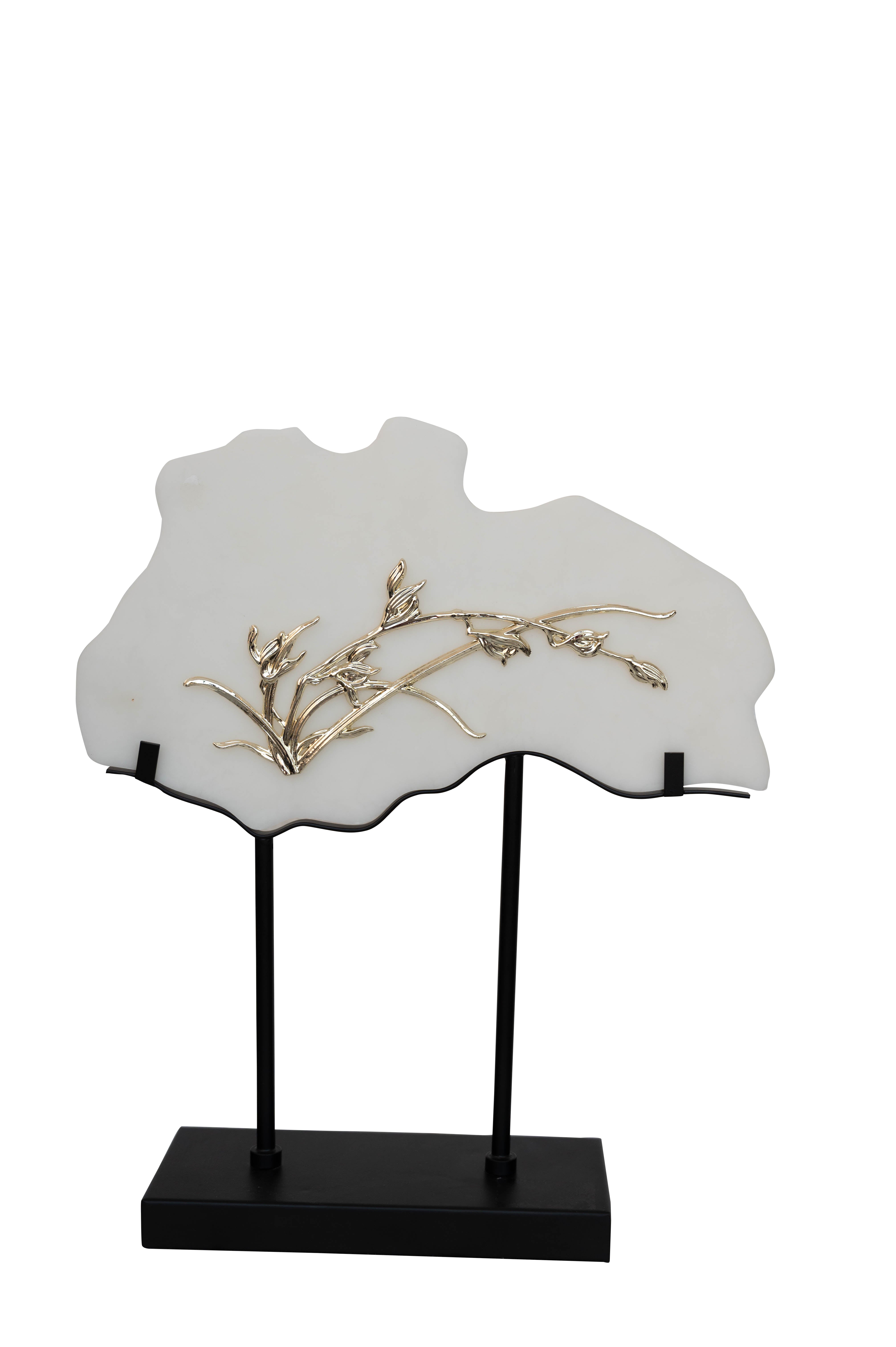 A frame with white panels and gold botanical detailing, on metal stands.