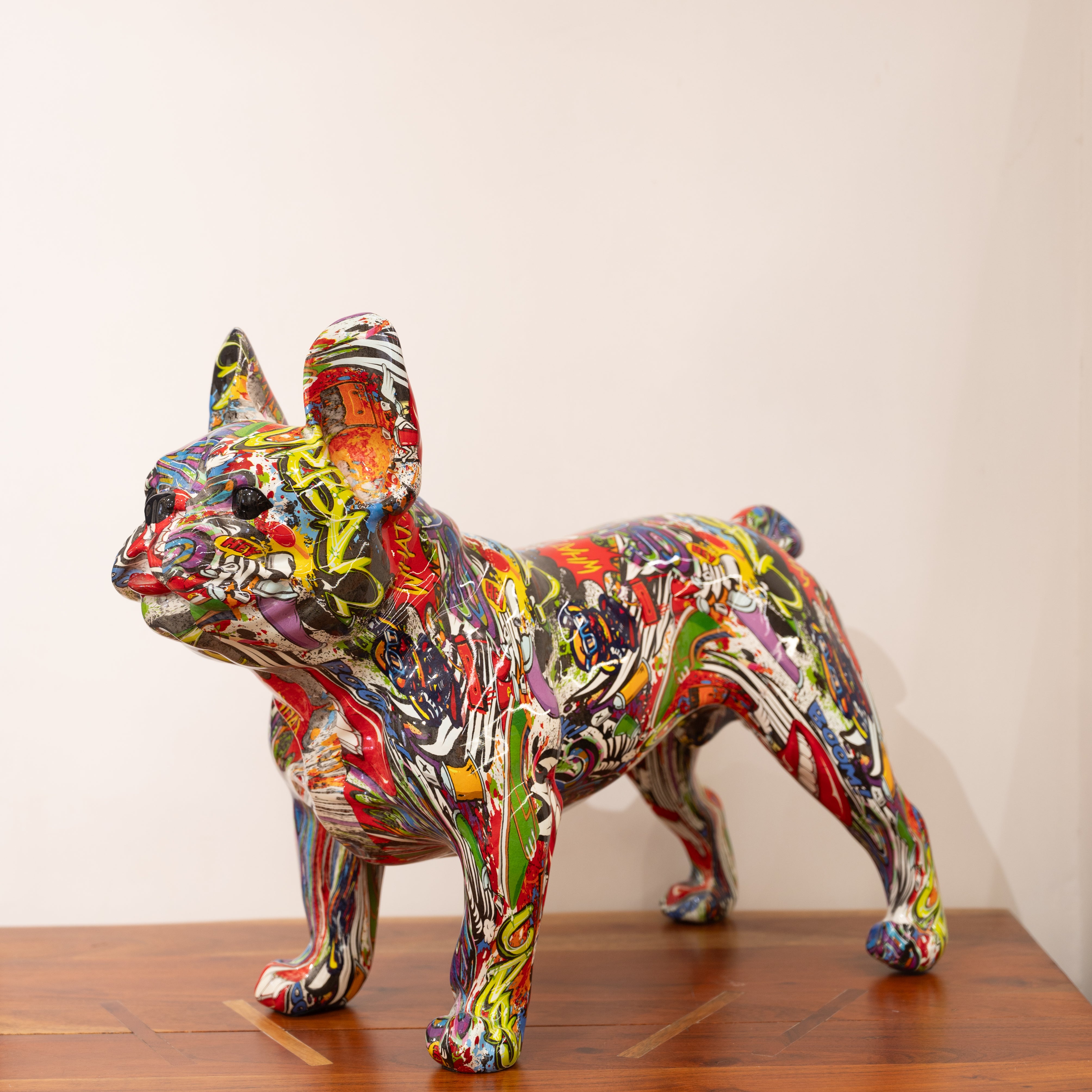 A multicolored, graffiti-style ceramic dog sculpture.