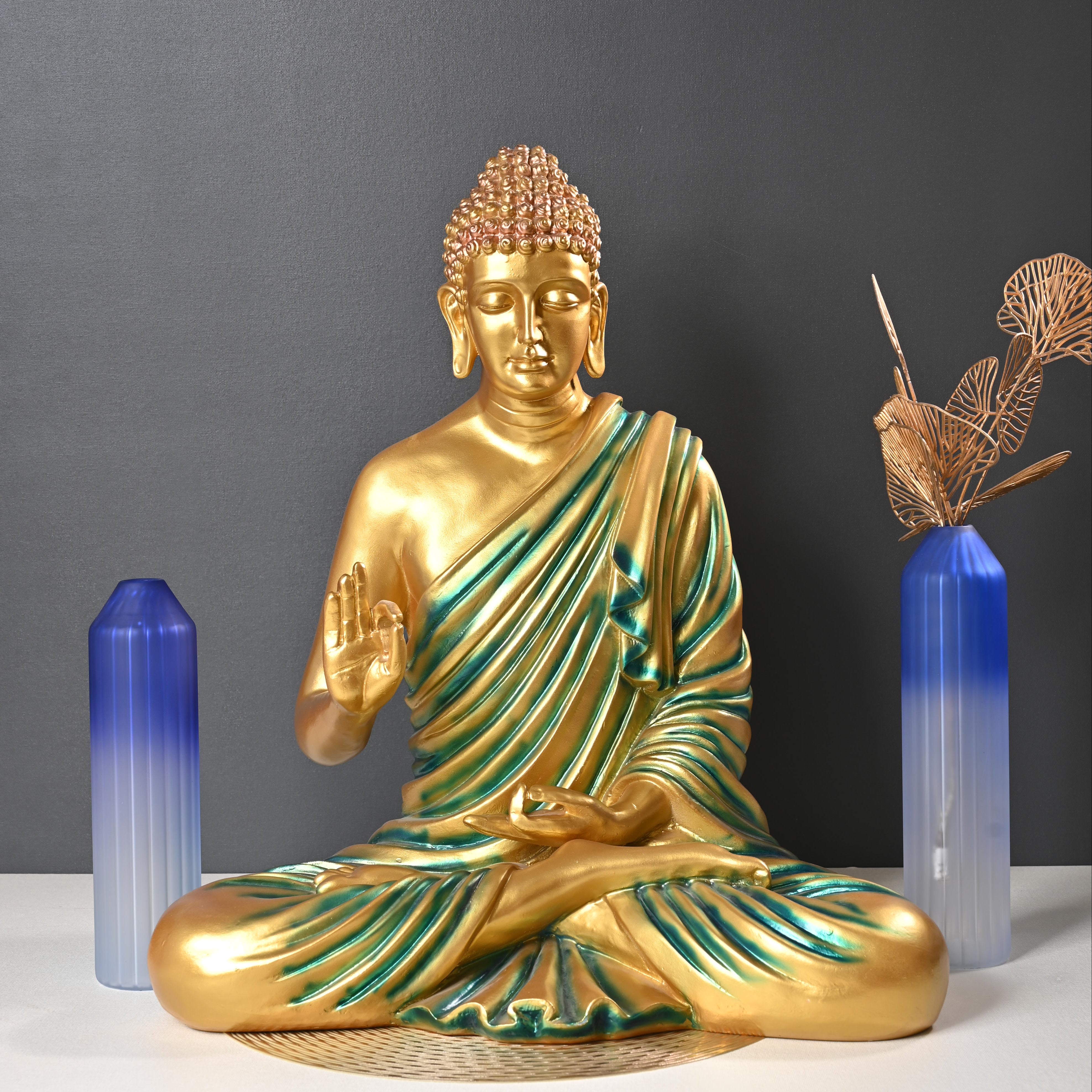 Gold and green Buddha statue with crystal on a dark background