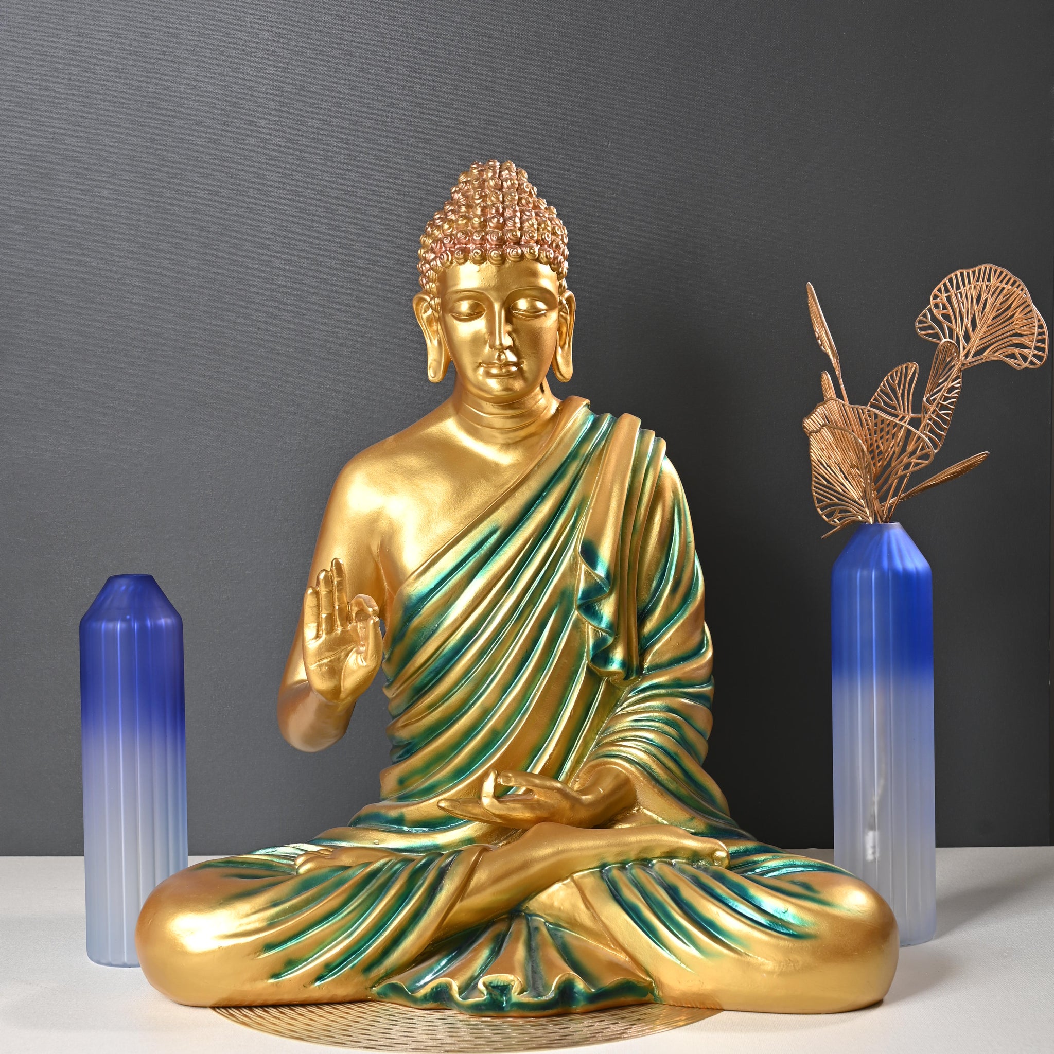 Gold Buddha statue on a dark surface with blue crystal points
