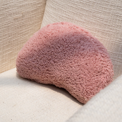 A pink crescent shaped cushion 