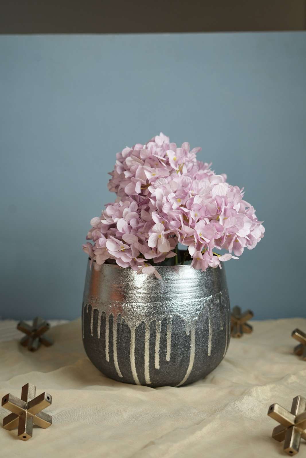 Silver metal planter featuring a drip-effect texture for contemporary home styling