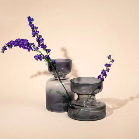 Two slate grey glass vases of different size