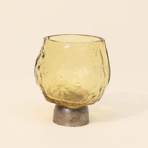 Two gold colored glass tea light candle holders with a textured surface and a metallic base.