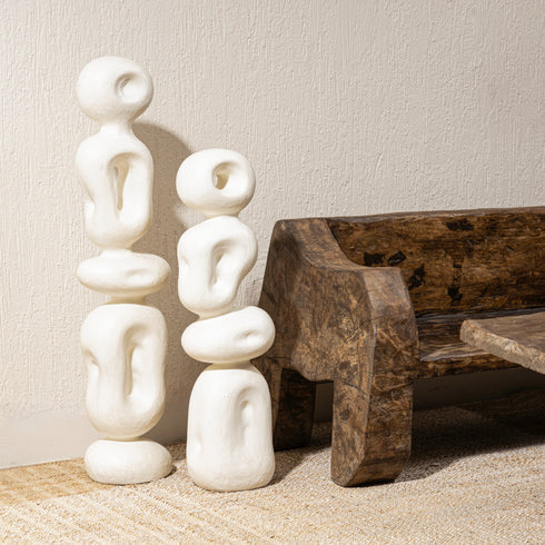 A white fiberglass sculpture with an abstract design