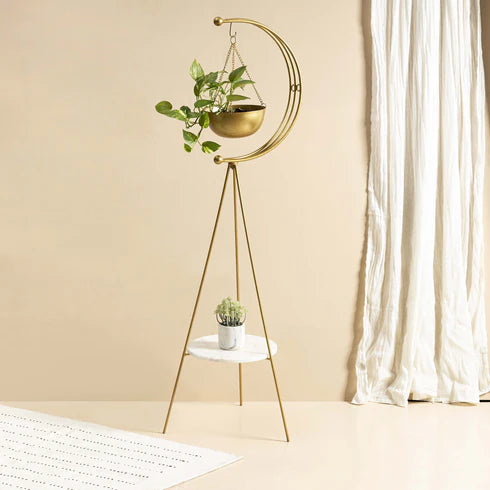 A luxurious mini tripod planter with a gold metal structure and white marble base