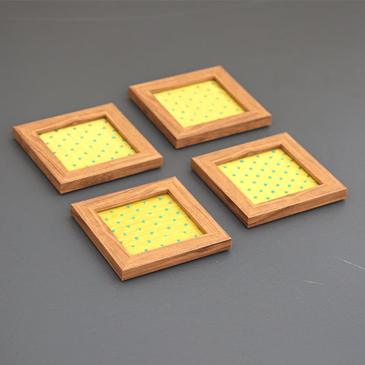 Set of four yellow and blue French knot coasters